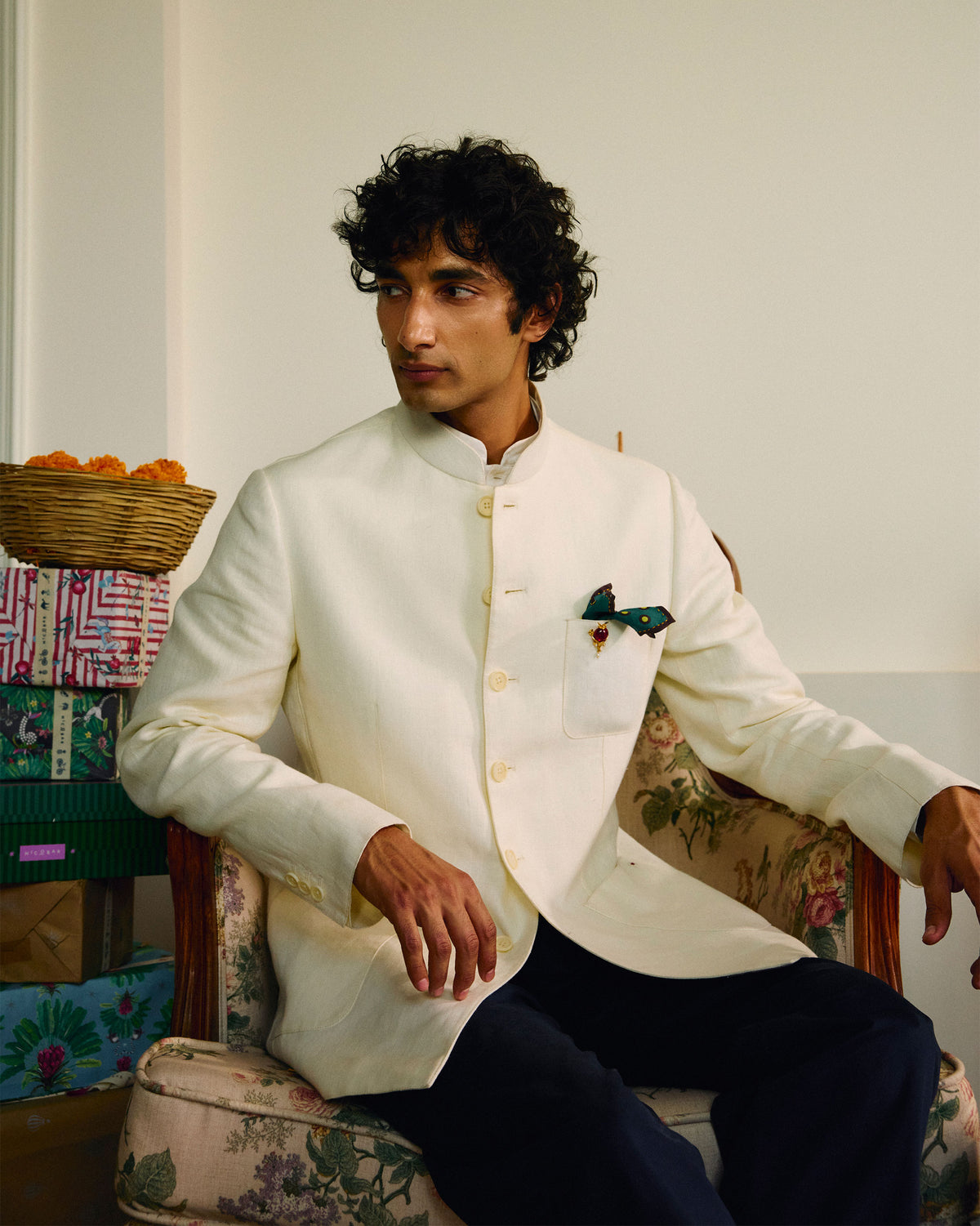 Person wearing an ivory Tahr Bandhgala jacket with a mandarin collar.