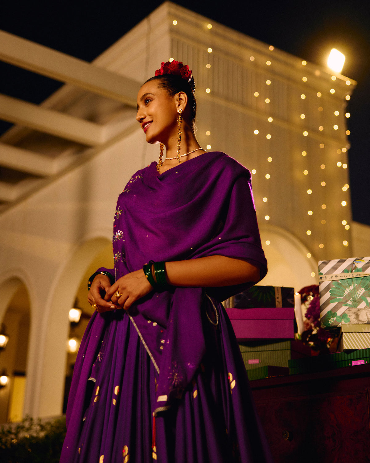 Person wearing a violet Bahaar shawl with embroidered floral motifs.