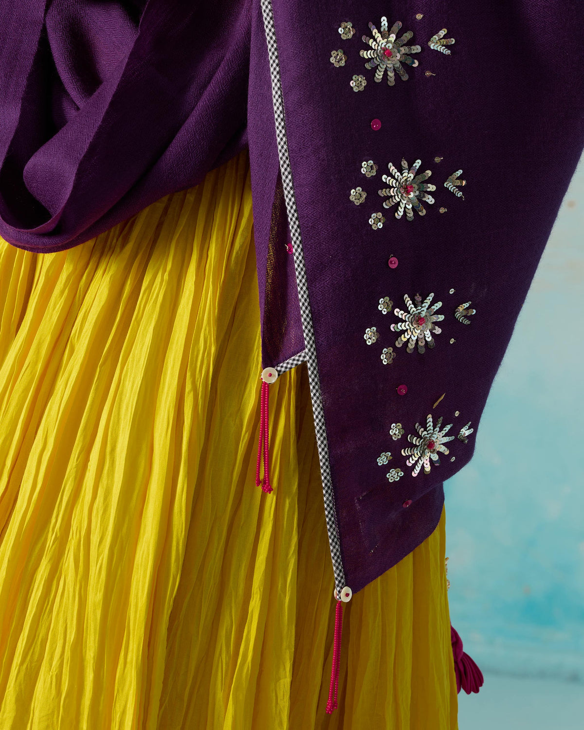 Close-up of the Bahaar shawl border with embroidered flowers and checked trim.
