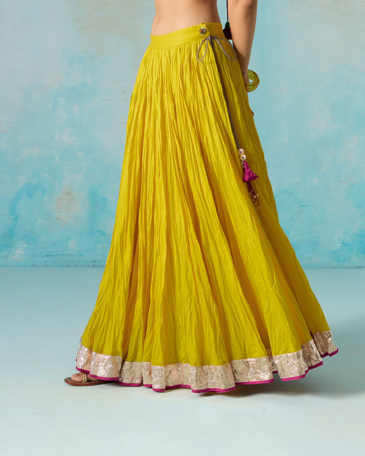 Back of a yellow Berura skirt with a gold hem border.