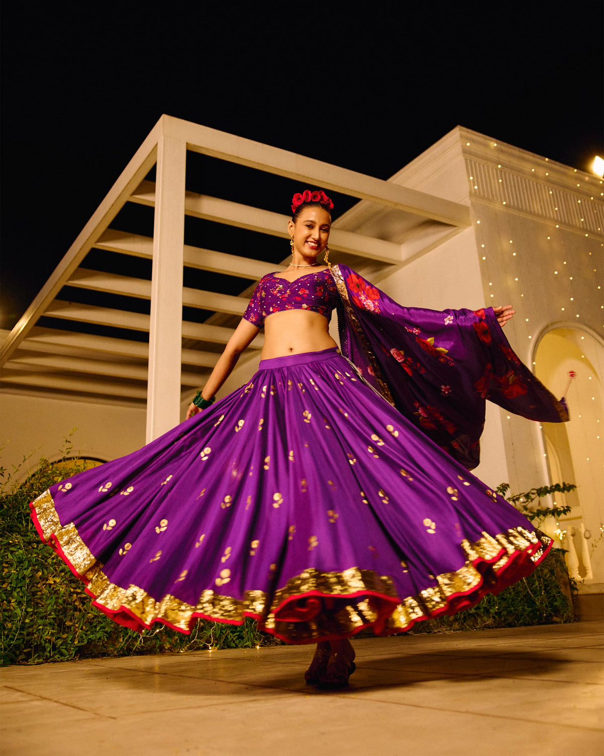 Person wearing a purple Saaya skirt with gold foil motifs and a gold border.