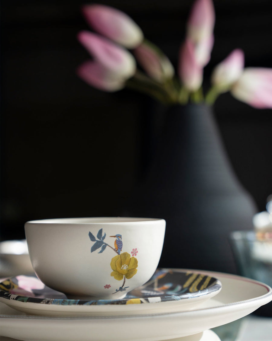 A Myra katori stacked on the plates, tulips behind.