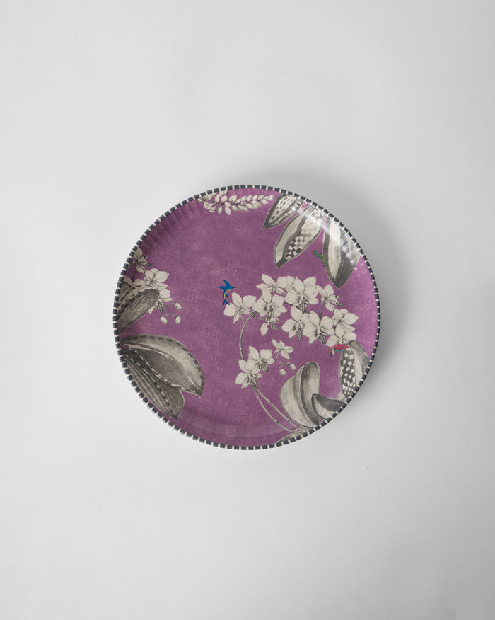 Overhead view of the lavender Reesha Quarter Plate with white flowers and grey leaves.