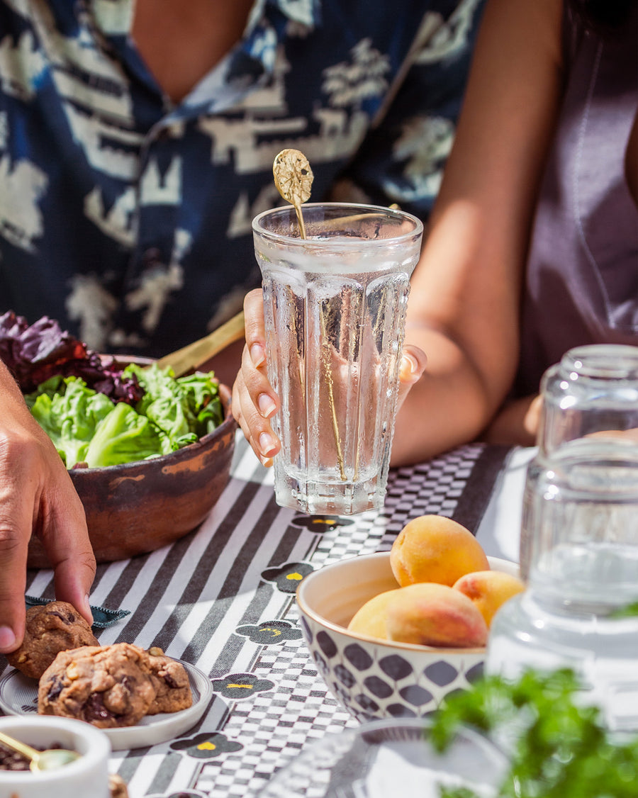 A Dawa Stirrer in a tall glass at the table.