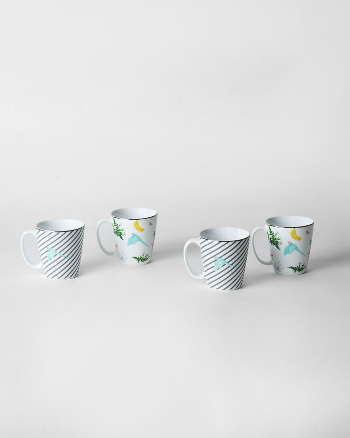 Four mugs in a row, stripes and parrots in turn