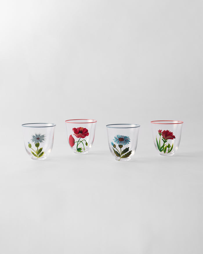 Four tumblers in a row, each with a different flower