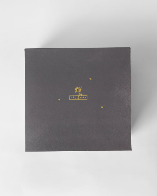 The closed charcoal box with a gold palm mark