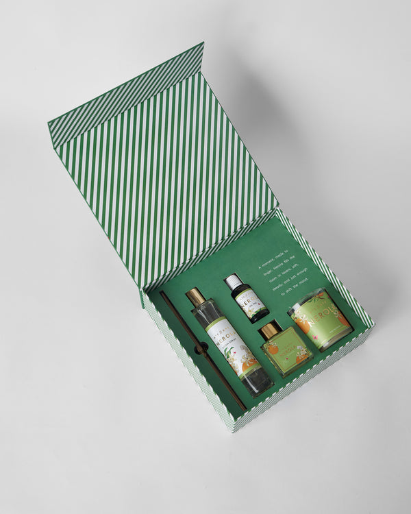 The open box with candle, spray, vial and diffuser
