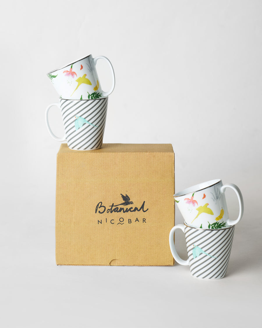Botanical mugs stacked on and beside a kraft Botanical Nicobar gift box