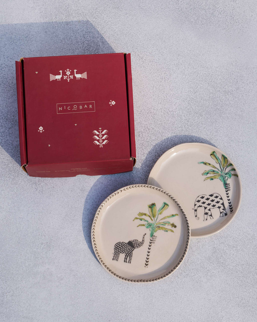 The Coastal Tea Plates beside a red Nicobar gift box.