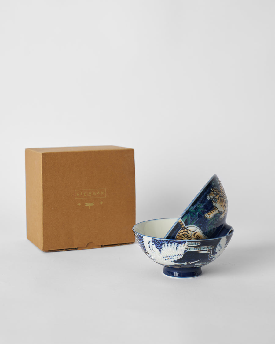 The two bowls nested beside a kraft Nicobar gift box