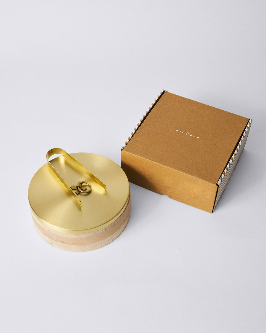 The Roti Box beside a Nicobar gift box with candy stripe sides.