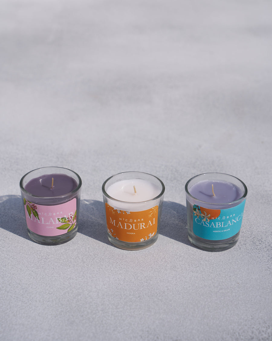 The three votives lined up unlit.
