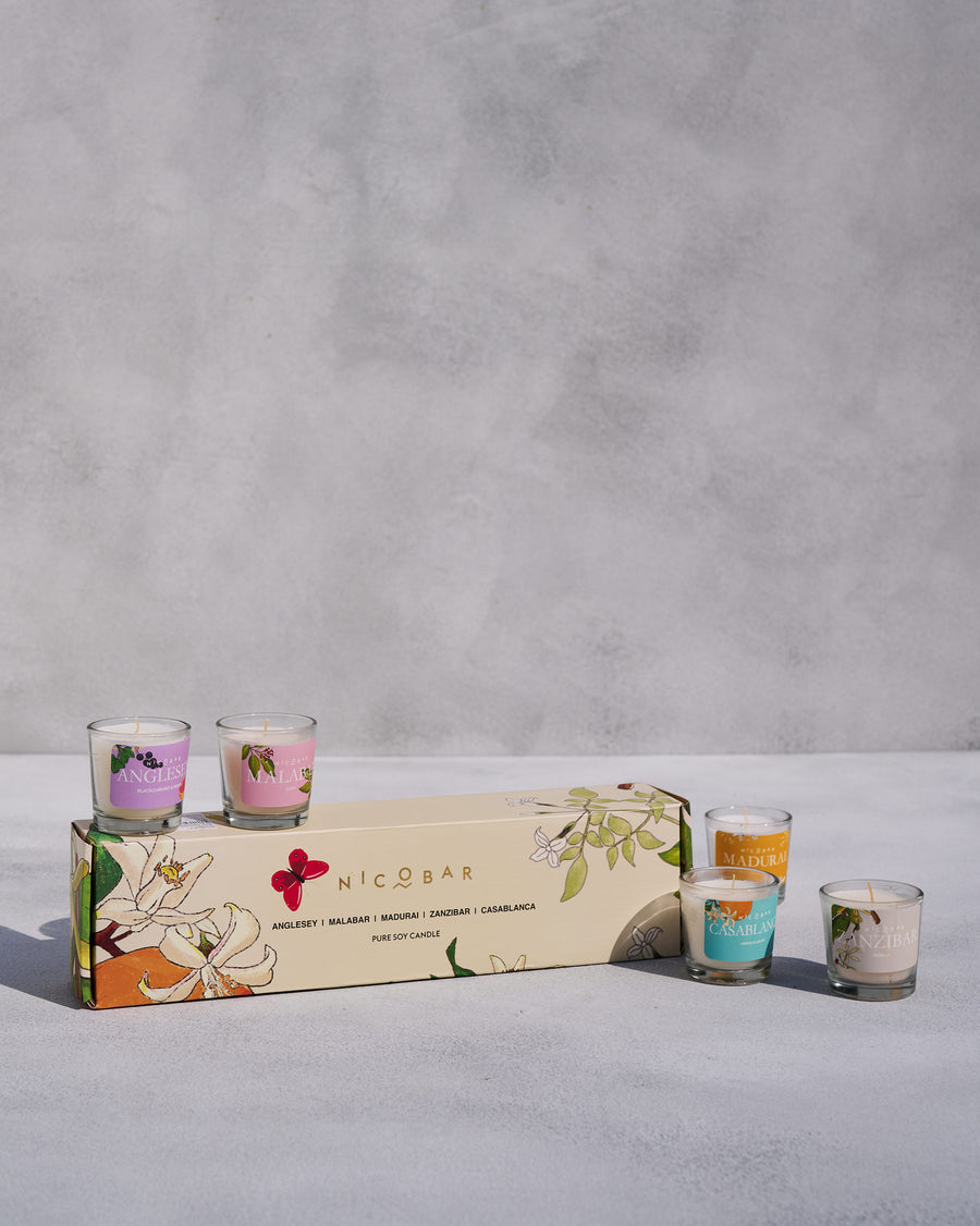 The five candles around their cream gift box.