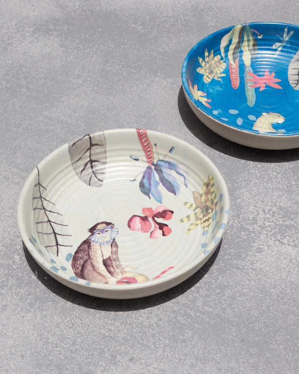 Close view of the cream bowl with a monkey and flowers