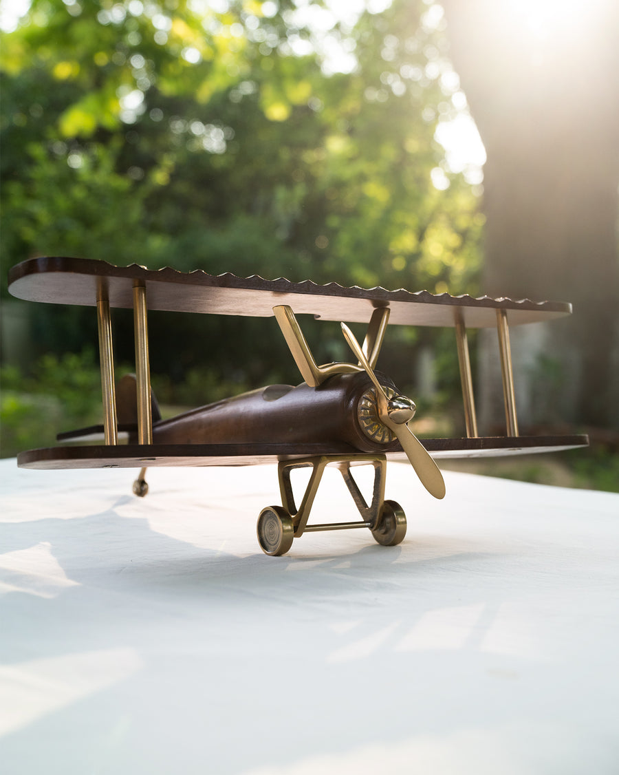 The wooden Beufort biplane on a table outdoors in evening light