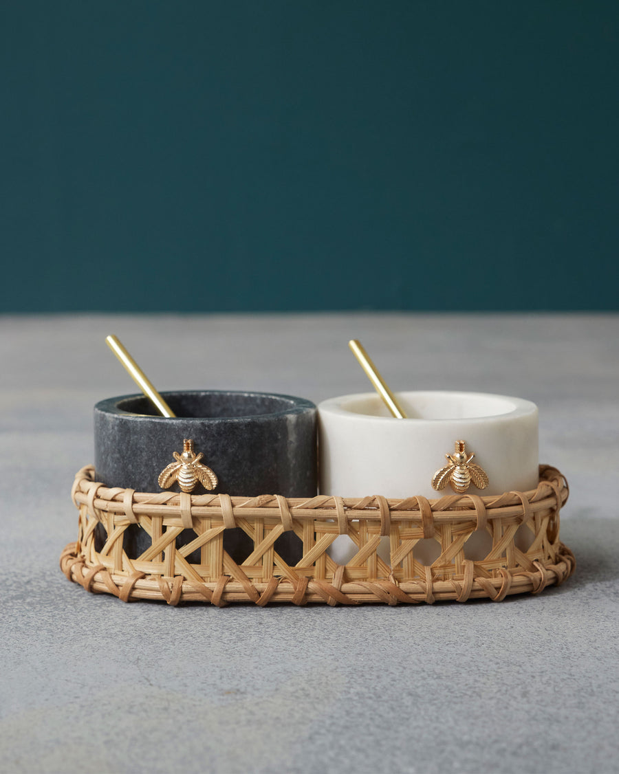 The two pots with spoons in their woven tray