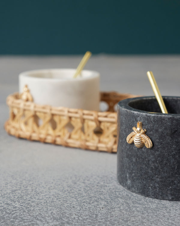 Close view of the charcoal pot with its gold bee and spoon