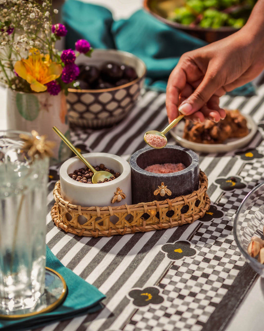 The Garo pots in use on a dining table, a hand reaching in with a gold spoon