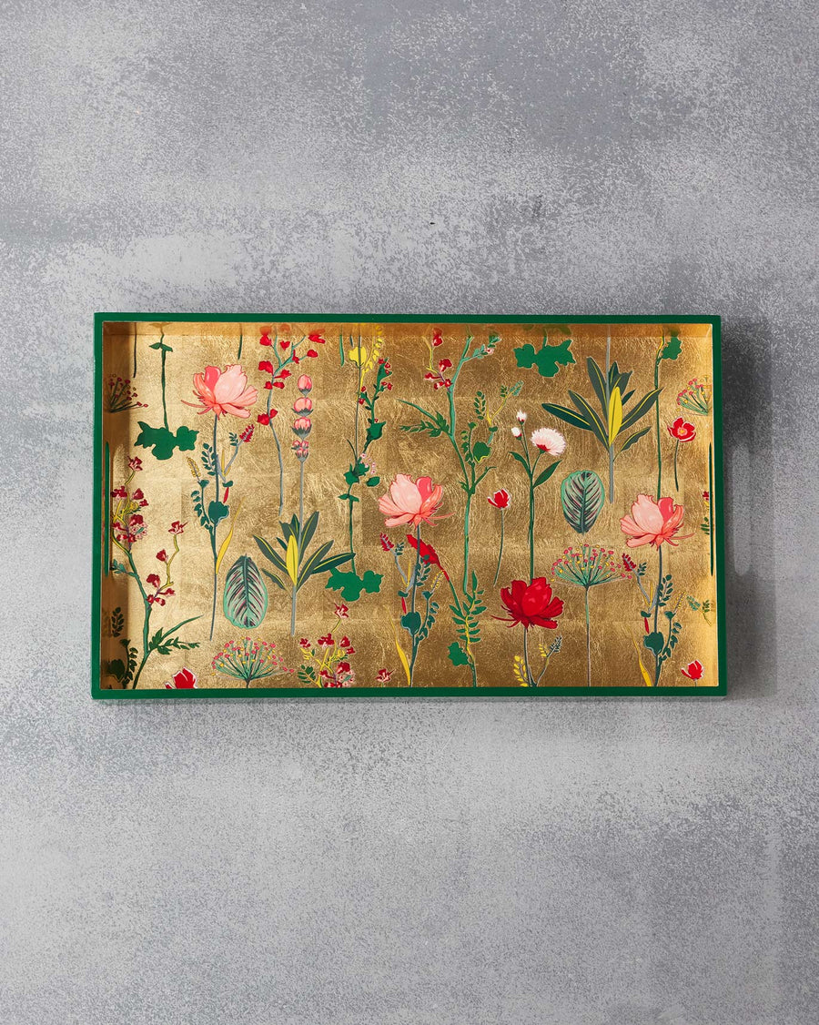 The Mahi tray from above, flowers on gold leaf inside a green frame