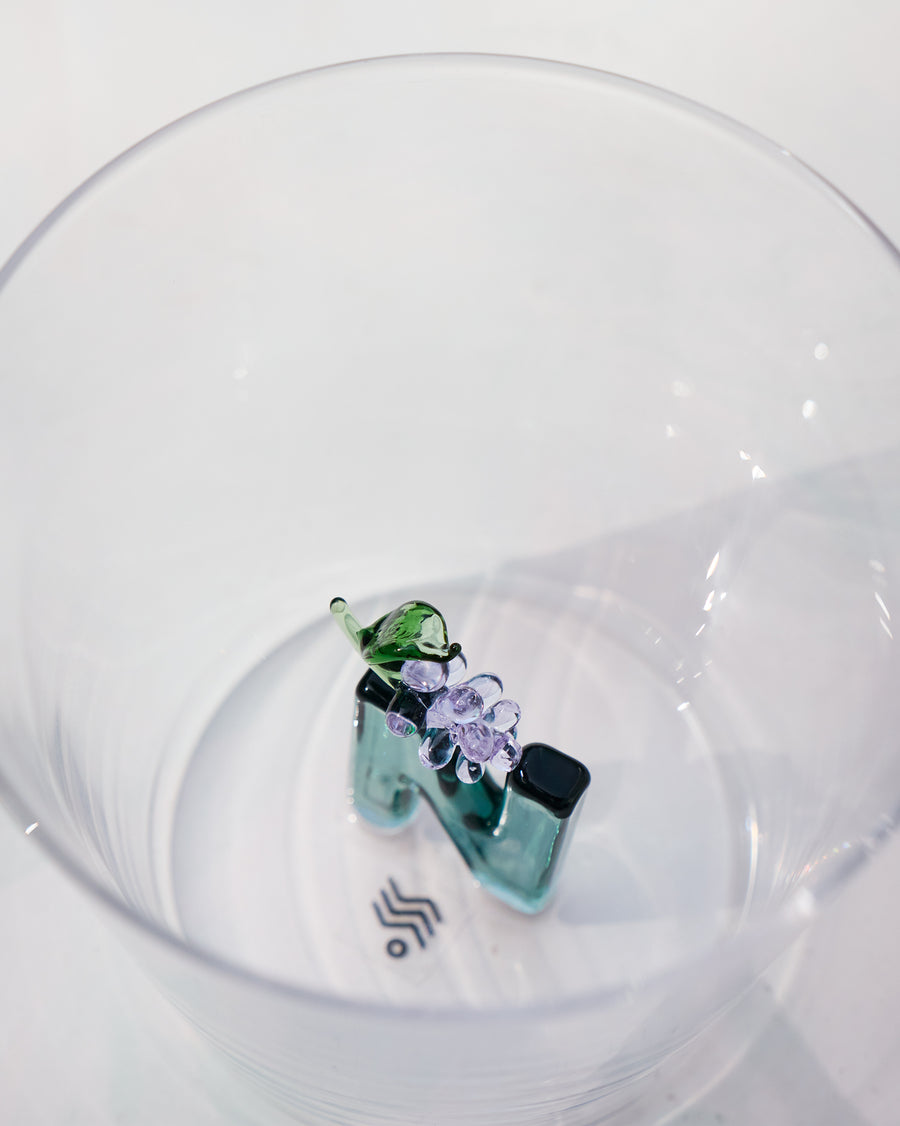 The glass beside its gift box.