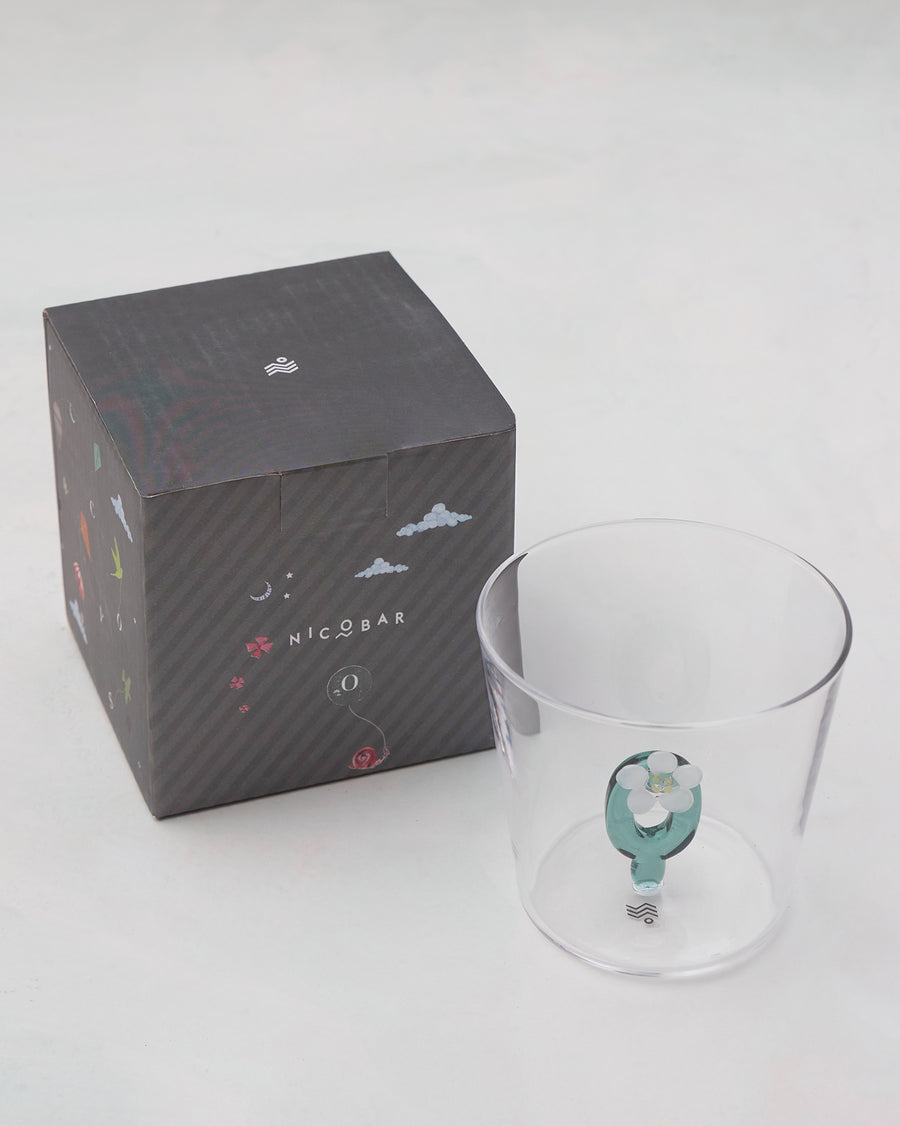 The glass beside its gift box.