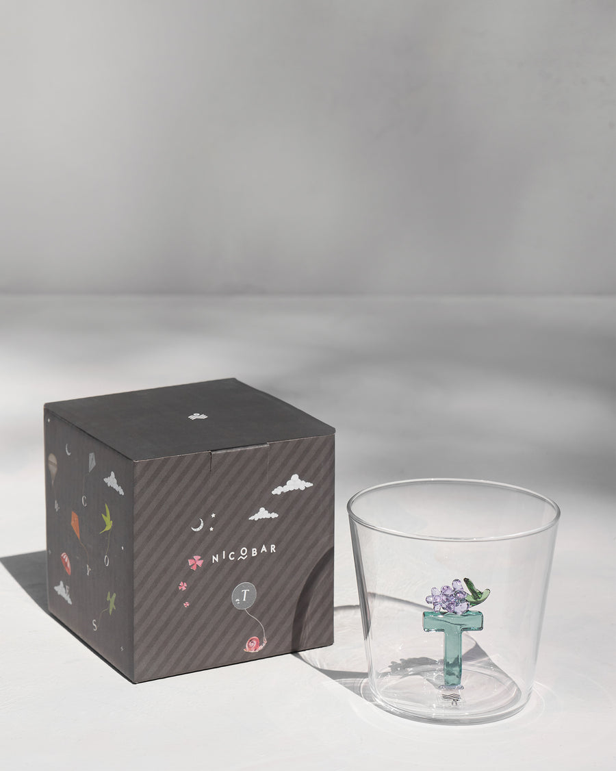 The glass beside its gift box.