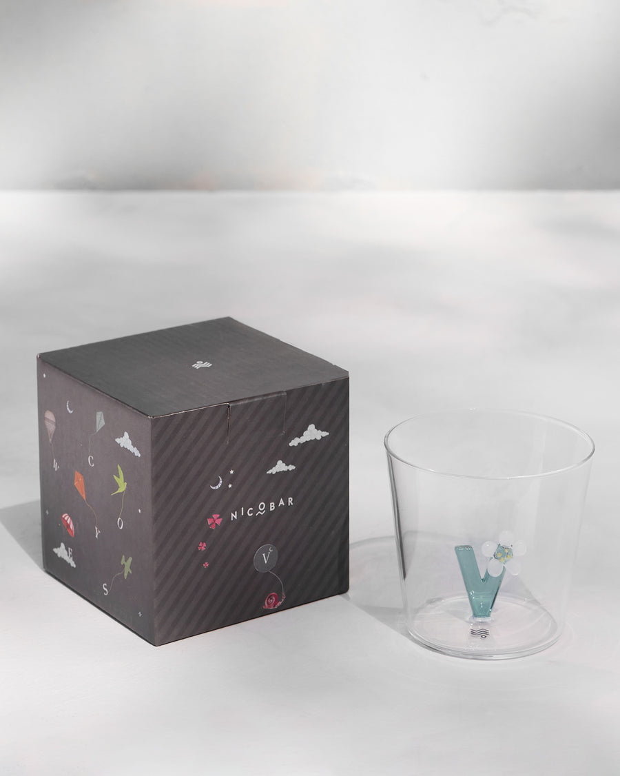 The glass beside its gift box.