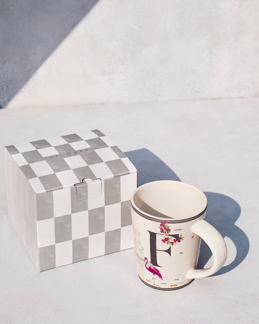 The Firefly Mug beside its chequered Nicobar gift box.