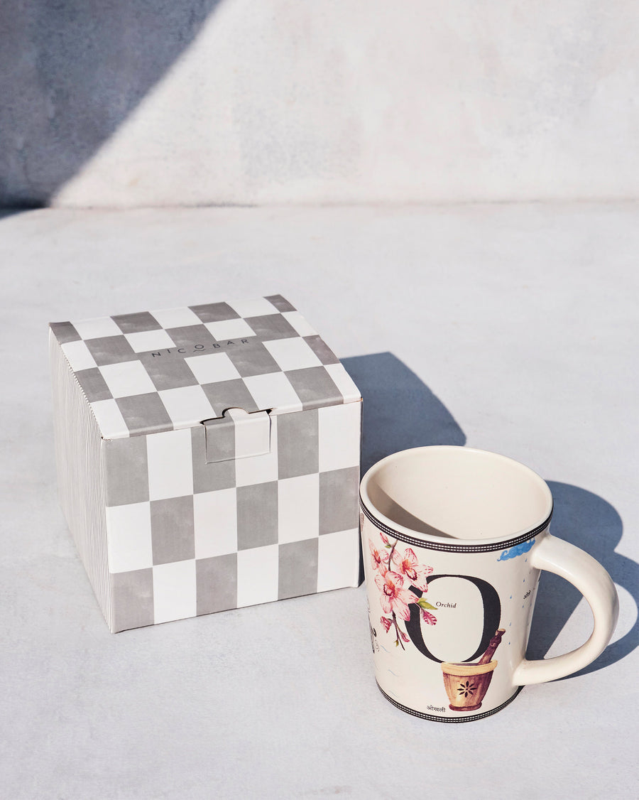 The Owl Mug beside its chequered Nicobar gift box.