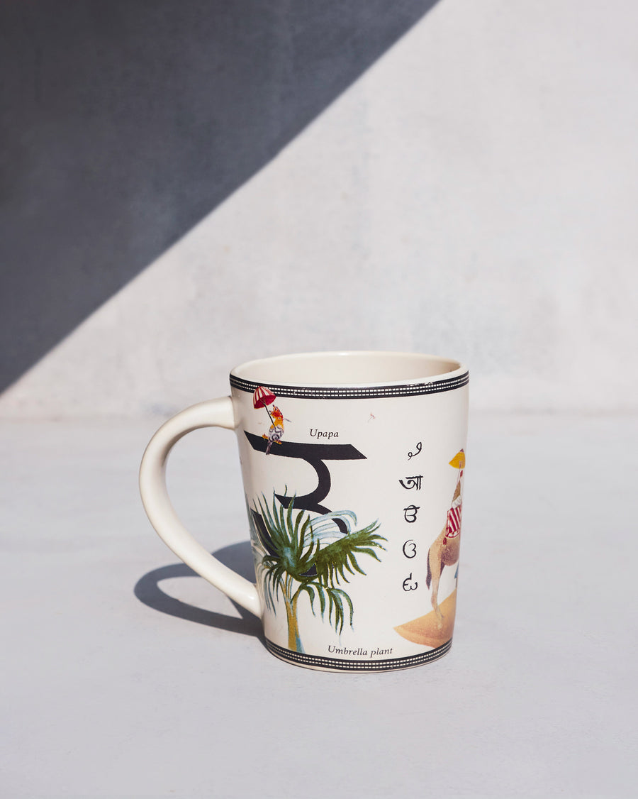 The Umbrella Mug side-on, with the letter उ.