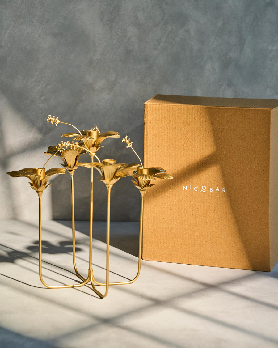 The candle holder beside its kraft Nicobar box