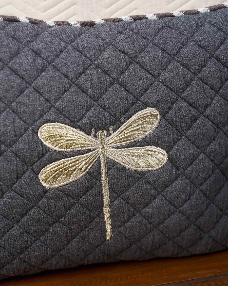 The embroidered dragonfly close up.