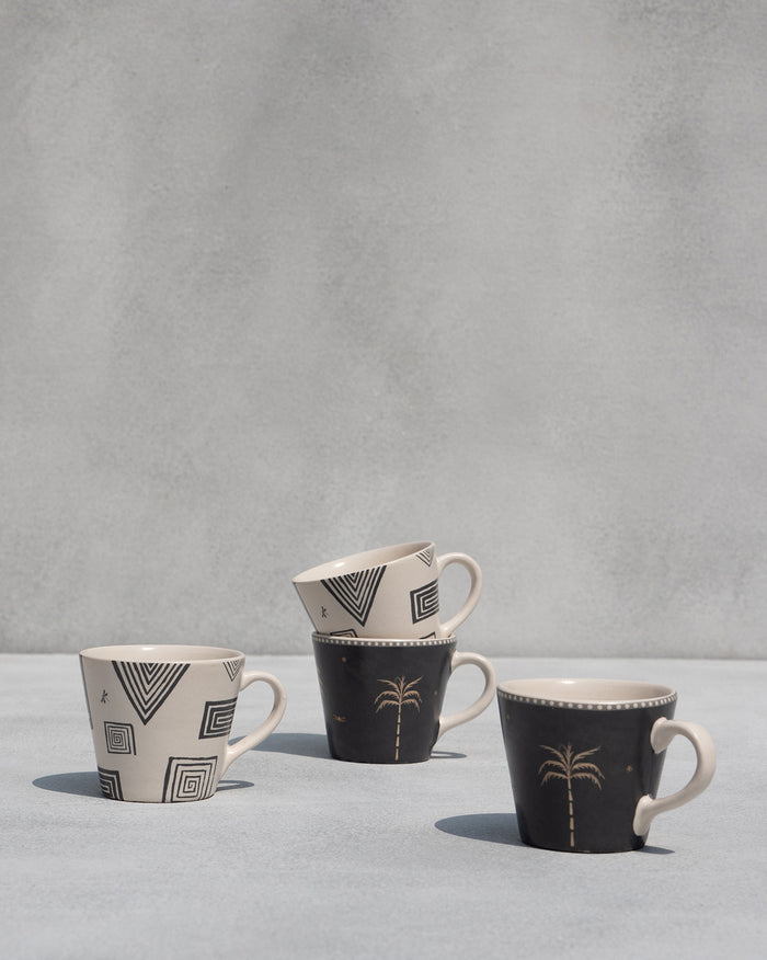 Mugs grouped in geometric and palm designs