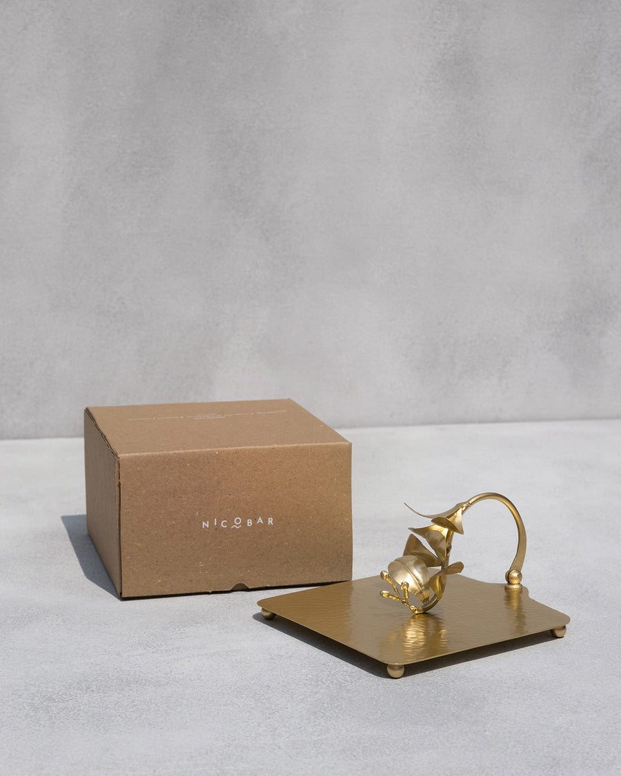 The napkin holder beside its kraft Nicobar gift box