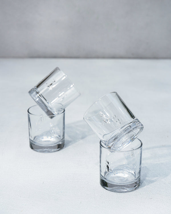 Two stacks of glasses balanced at an angle