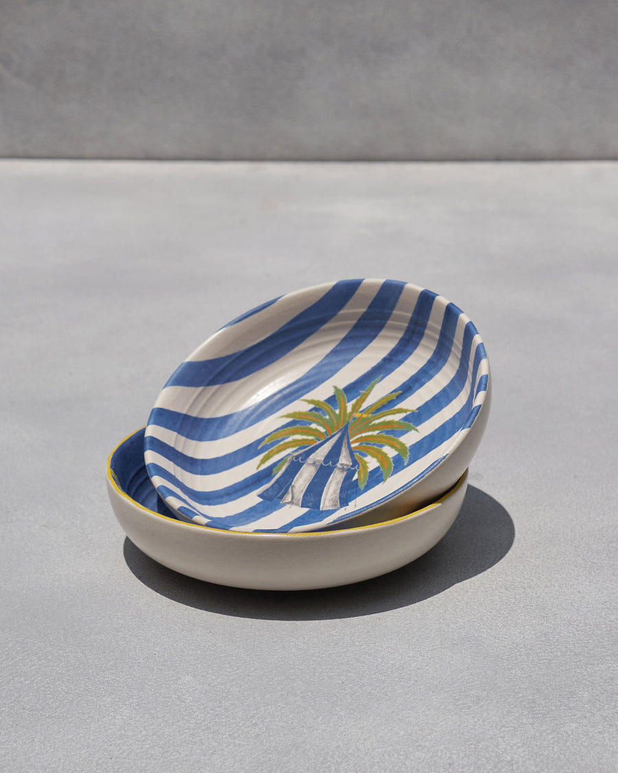 The striped bowl stacked on the blue one