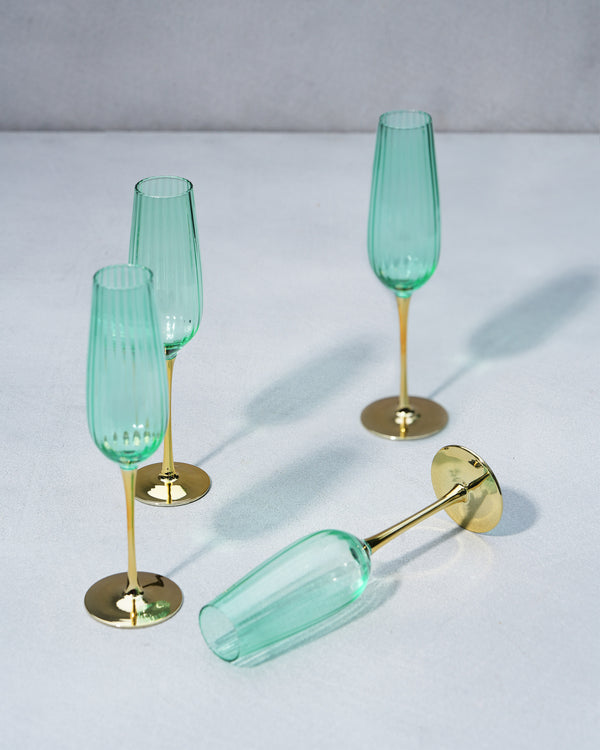 Three flutes standing and one on its side, ribs catching the light