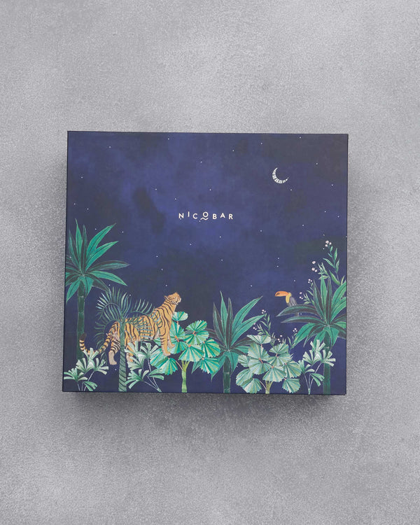The closed navy box with a tiger, a toucan and a crescent moon in a jungle