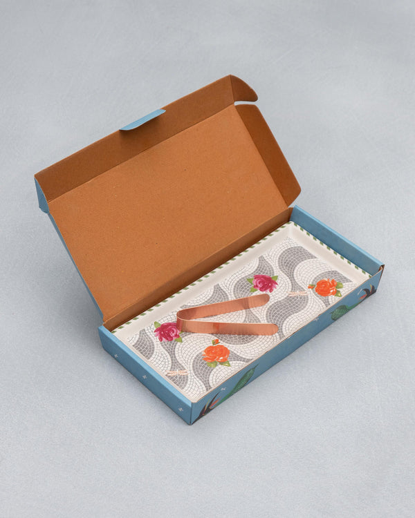 The open box with the tray and tongs inside