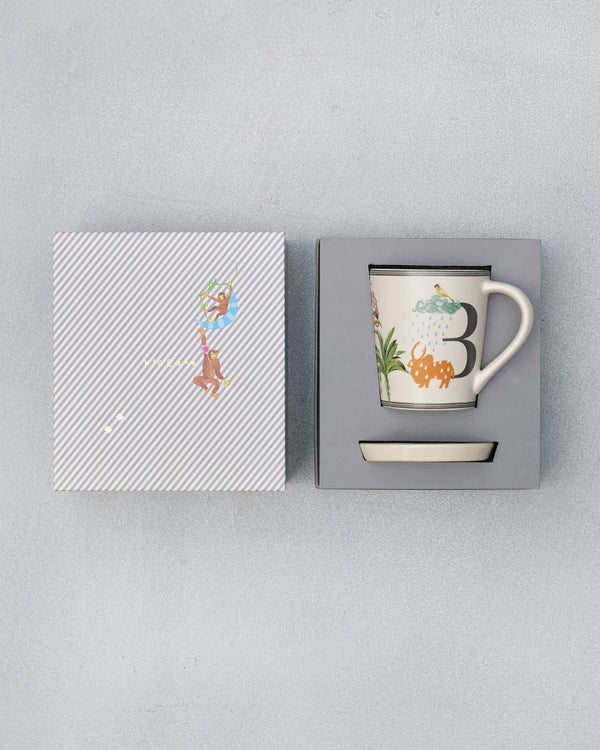 The open box with the mug and coaster inside