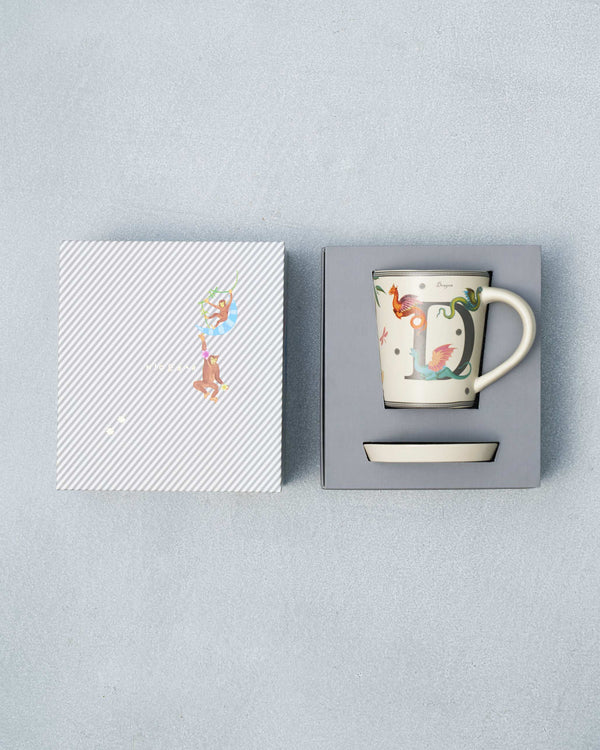 The open box with the mug and coaster inside