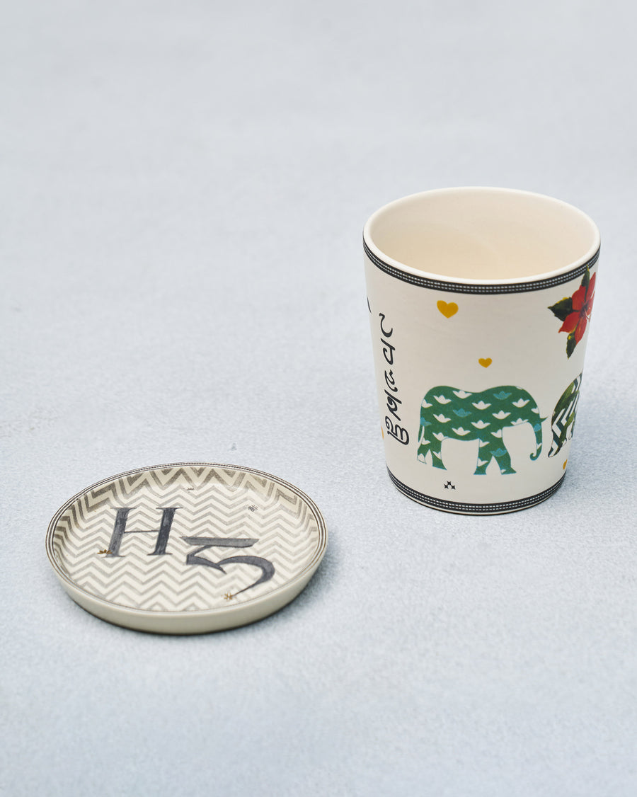 The H mug beside its coaster