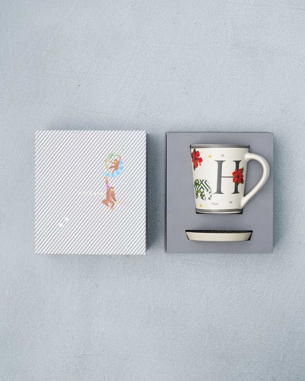 The open box with the mug and coaster inside