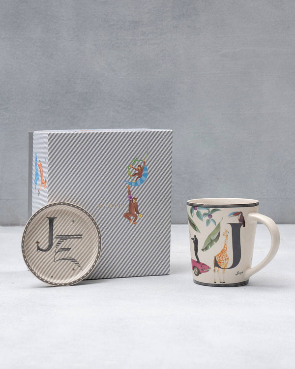 The J mug and coaster beside the striped gift box