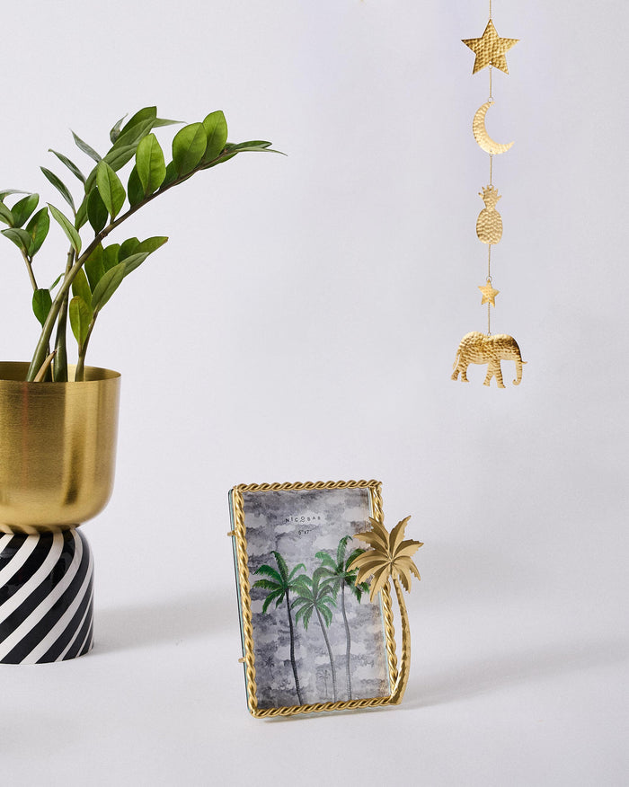 The frame on a shelf among gold decor