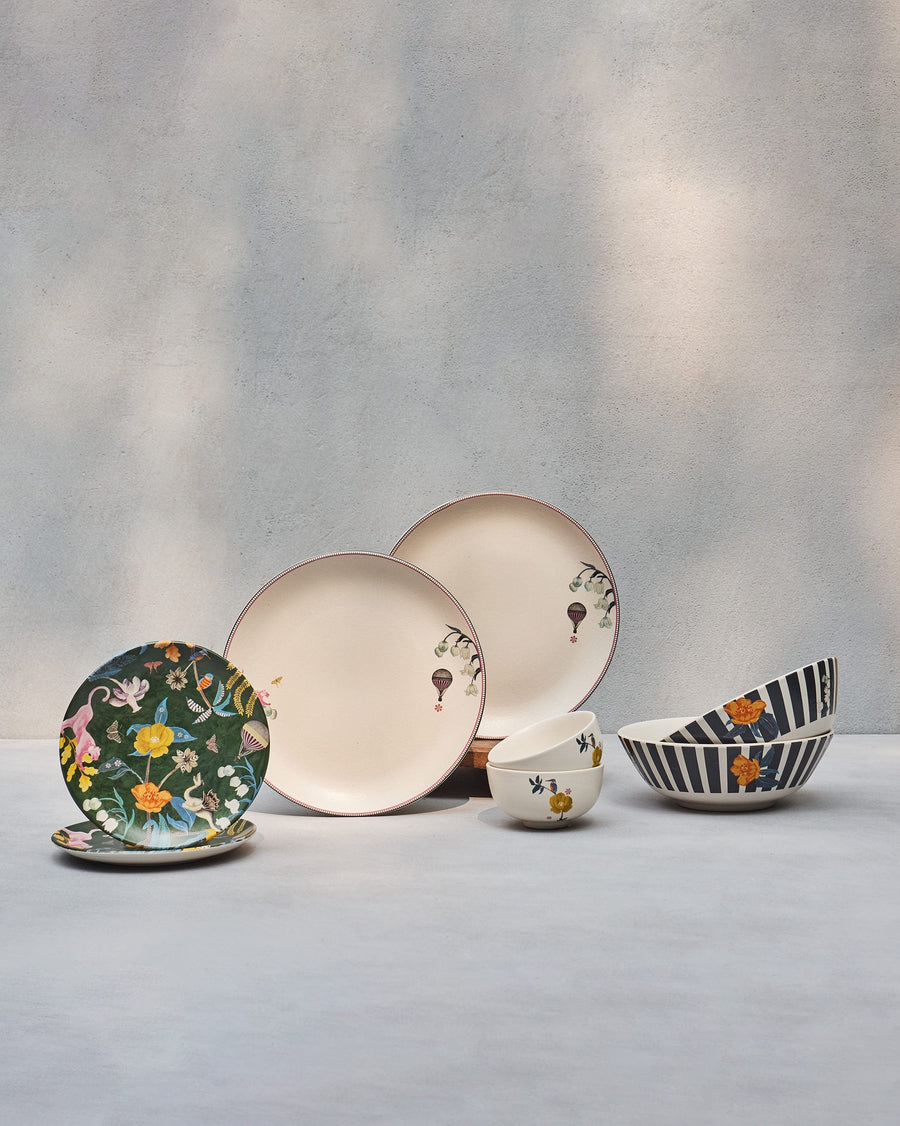 The Myra Dinner Set for two: plates, katoris and striped curry bowls.