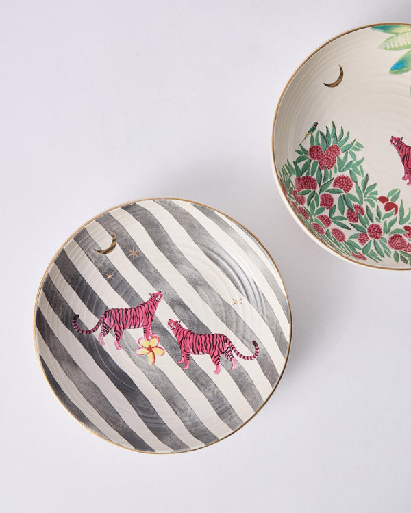 A bowl with grey stripes and two pink tigers