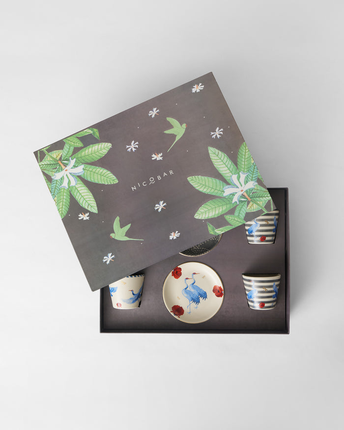 Open Dancing Crane gift box with crane plates and striped cups in a foam insert.