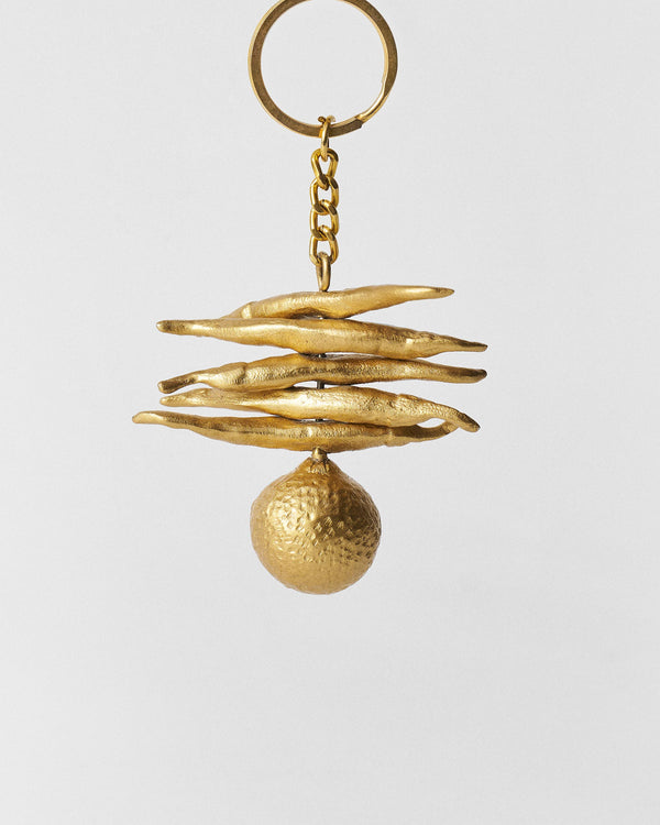 The keychain hanging, lemon at the base